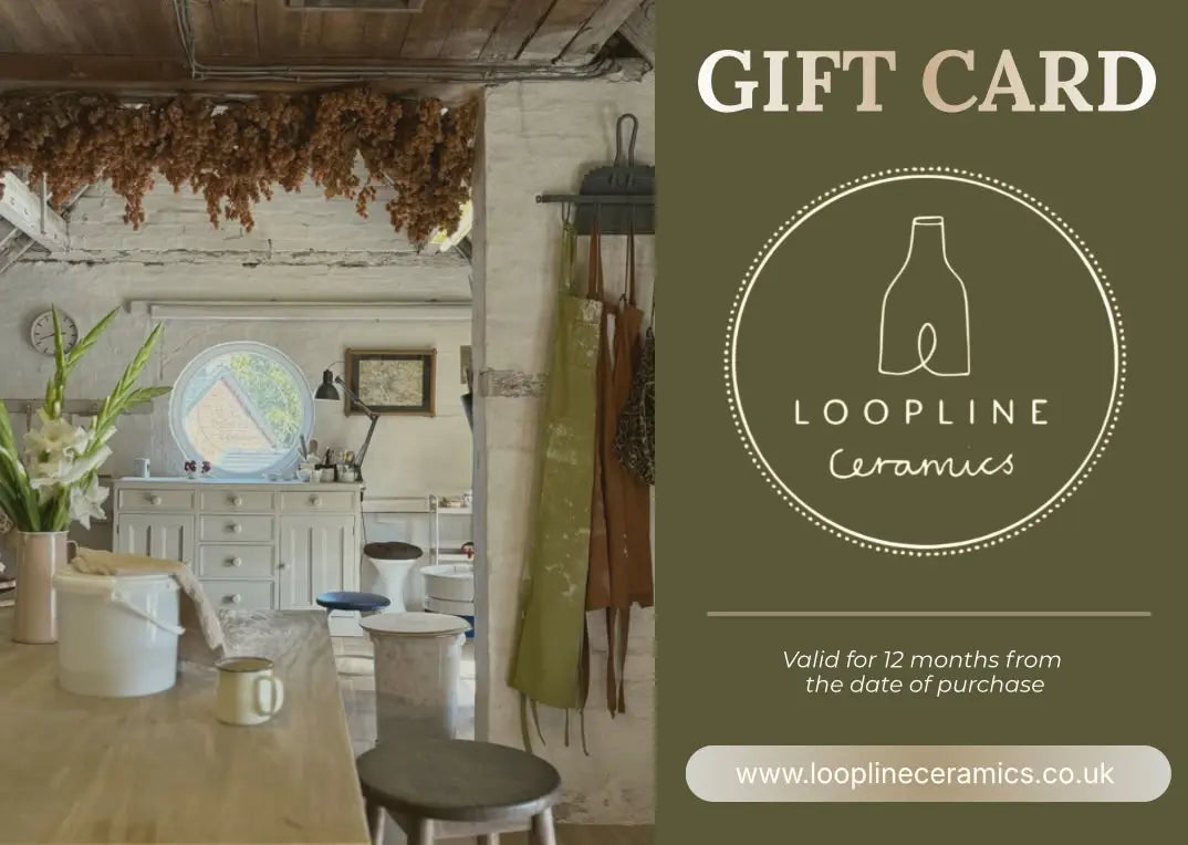 A gift card for Loopline Ceramics featuring a rustic kitchen interior on the left and a dark olive-green panel on the right with the text 'GIFT CARD', the Loopline Ceramics logo, validity details, and the website.